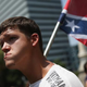 A Ku Klux Klan supporter carries the Confederate flag during a demonstration at the Statehouse July 18, 2015, in Columbia, S.C.
John Moore/Getty Images